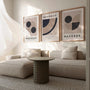 neutral geometric bauhaus poster set in modern office workspace
