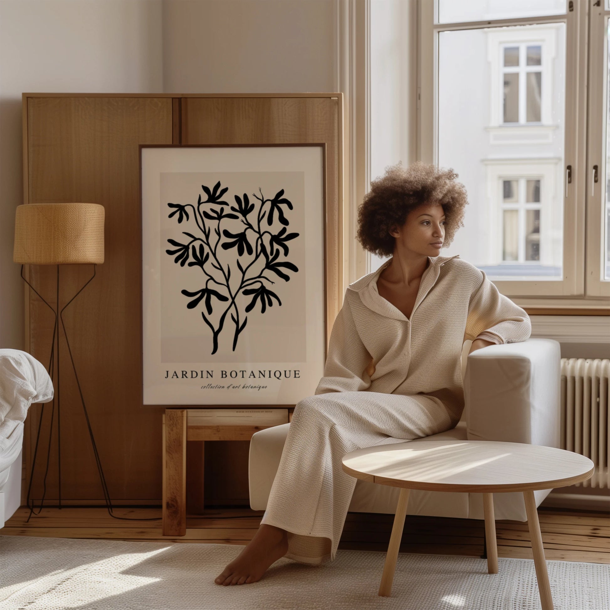 Black botanical branch poster displayed in gallery wall with minimalist neutral interior