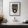 Close up of botanical vase poster showing bold black abstract shapes