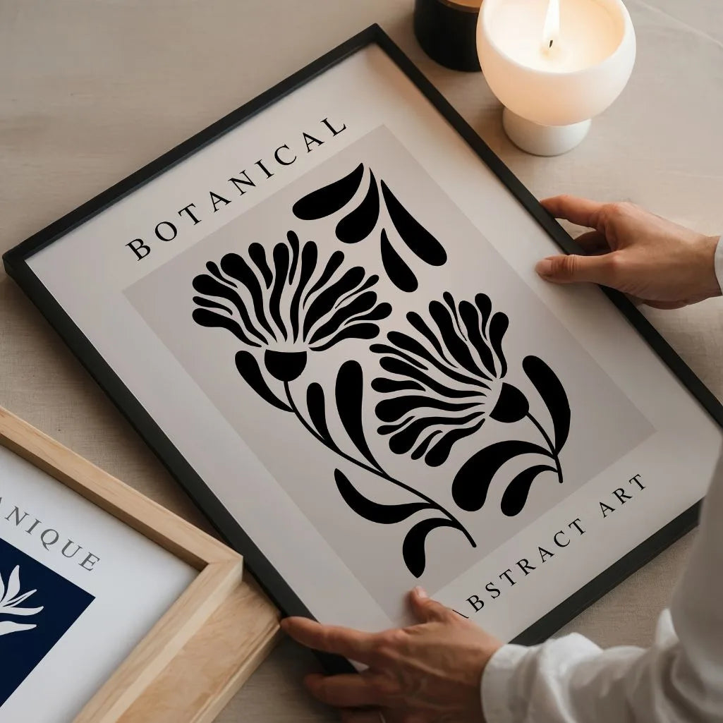 Black botanical graphic poster in minimalist bedroom interior