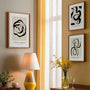 Minimalist line art poster set with flowing lines in black and beige tones